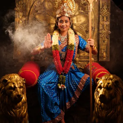 A powerful portrait of a model dressed as a Devi, complete with a trident prop, ornate throne, and smoke effects for a dramatic, divine look. All elements are part of my rental package.