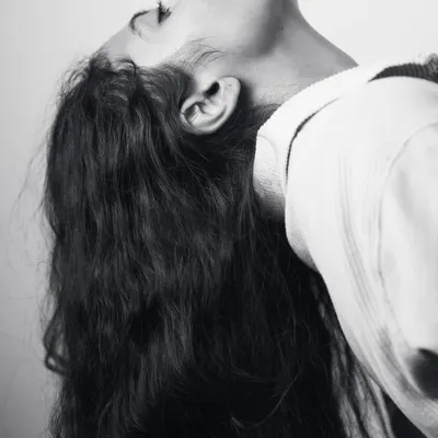 An expressive pose from my boudoir series, focusing on the curve of the neck and flow of my hair. This shot is about capturing emotion through body language in a simple, artistic way.