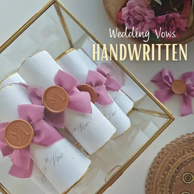 Your wedding vows, handwritten and preserved as timeless scrolls. Each one is finished with a silk ribbon and a custom wax seal, ready to be treasured long after your special day.