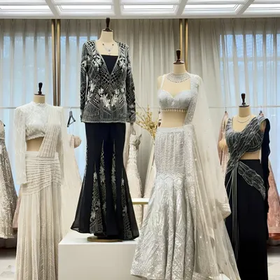A snapshot of our latest collection on display. This monochrome palette features a mix of modern silhouettes, from mermaid-style lehengas to chic pant sets.