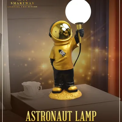 Bring a touch of space-inspired elegance to your home with this Astronaut Lamp. It's a fun and futuristic design that provides a warm glow, perfect for a kid's room or a modern desk.