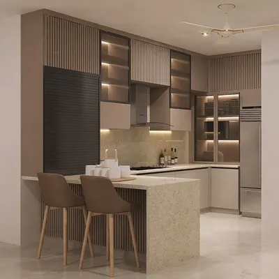 This kitchen design balances warm, earthy tones with modern functionality. We included a spacious breakfast island for casual dining, while the glass cabinets with internal lighting beautifully display crockery and add depth to the space.