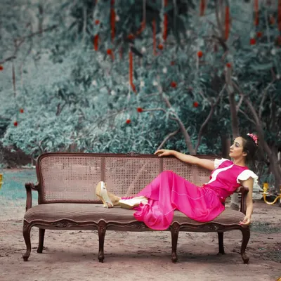 This fuchsia pleated maxi dress is the definition of indie-chic. The artistic setting highlights its modern silhouette and bold color, making it a statement piece for any event.