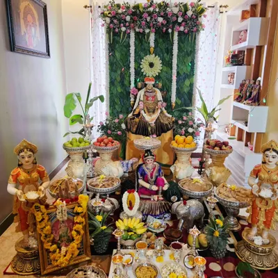 A complete setup for a Varamahalakshmi puja at home. I used a banana leaf backdrop, a floral arch, and a detailed arrangement of offerings and idols to create a sacred space in the living room.