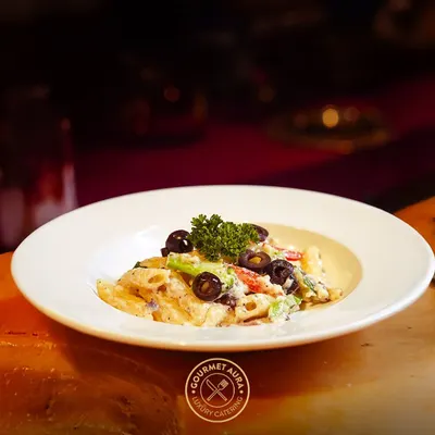 A classic penne pasta dish with a creamy sauce, black olives, and fresh parsley. A simple, elegant, and delicious option from our Italian menu.