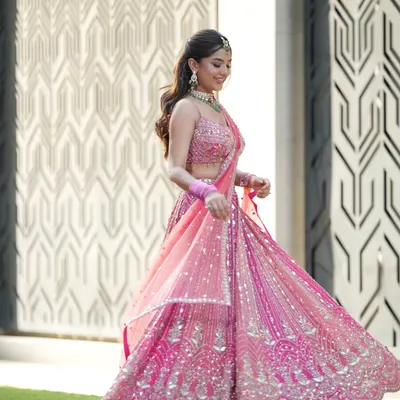 This pink lehenga was made for a fairytale moment. I draped the dupatta to flow effortlessly, allowing for a beautiful twirl that captures the joy of a Mehendi or Sangeet celebration.
