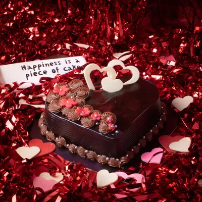 Our 'Love you Forever' Valentine's Cake is a heart-shaped Dutch truffle masterpiece. Adorned with delicate flowers and chocolate hearts, it's the perfect centerpiece for a romantic celebration.