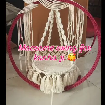 A beautiful macrame swing for Kanha Ji, perfect for Janmashtami celebrations. This design features a large pink-wrapped ring and intricate white knotwork for the seat.