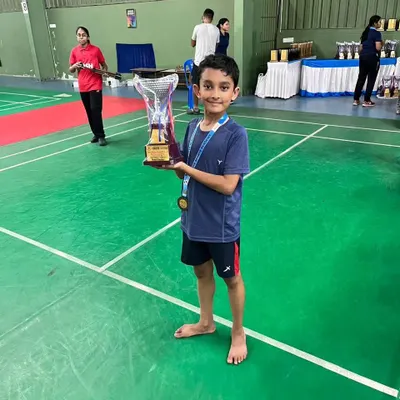 Here is our trainee Pratham on the court, proudly holding his trophy after securing a bronze medal in the Under-11 boys singles at the 2024 Karnataka state ranking tournament.