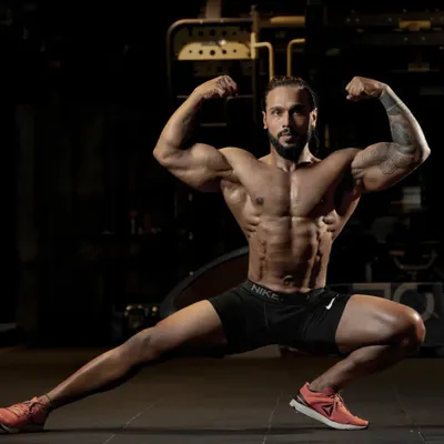 A classic bodybuilding pose showing overall muscularity, from the biceps and chest to the leg definition. This is what peak physical condition looks like.