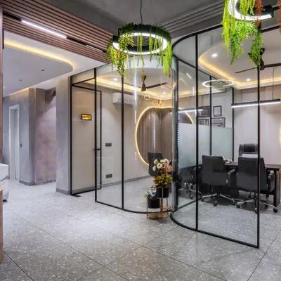 Welcome to the Shri Ram Construction office, a modern workspace I designed in Behra Enclave. The design features curved glass partitions, terrazzo tiles, and hanging planters to promote creativity and collaboration.