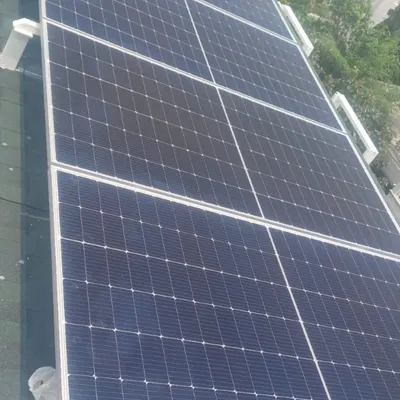 A clean installation of high-efficiency solar panels on a prefab home's roof. This system is designed to generate enough power for the home, reducing its carbon footprint and utility costs.