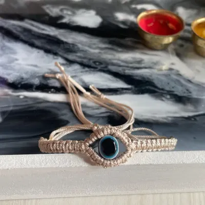 From my Rakhi collection, this is a beautiful evil eye bracelet, hand-knotted to protect the bond you share with your sibling.