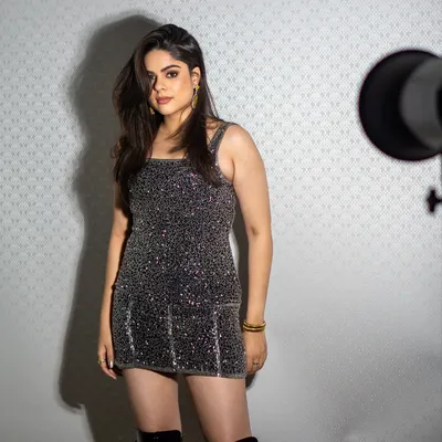 For this lookbook, I styled a sparkling silver sequin mini dress paired with thigh-high black boots. The look is all about confident glamour, perfect for a night out.