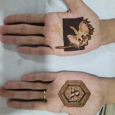 A closer look at the groom's henna I did for my fiancé. One hand has a White Egret Orchid, and the other has our initials in a hexagonal frame.