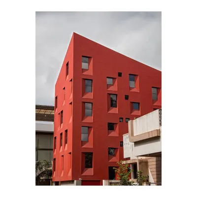 Our Stacked Student Housing project, completed in 2016, redefines density on a tight 111.5 Sq.m site. The form and fenestration are a direct product of the building's section, layering private living spaces efficiently.