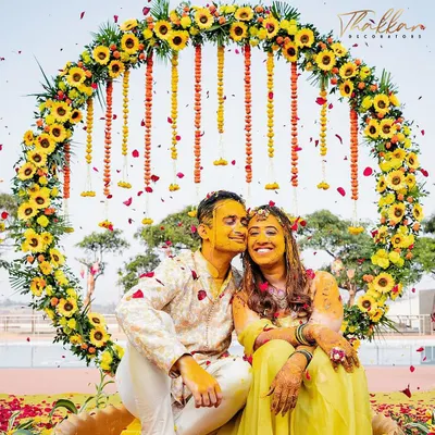 A perfect shot of the happy couple during their Haldi ceremony, framed by a circular backdrop of sunflowers and marigolds. I design these spaces to be both beautiful for the ceremony and perfect for photos you'll cherish forever.