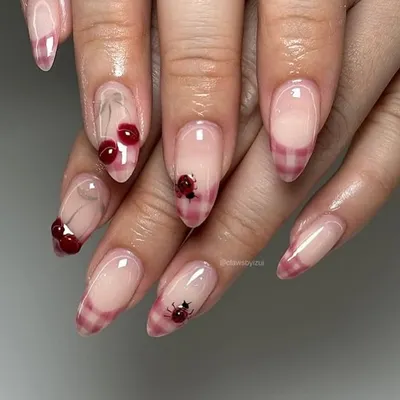 Loving the cherry trend. This cute set features a sheer base with a pink plaid French tip and tiny, detailed cherry and ladybug art.