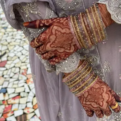 The beautiful result of natural henna. This rich maroon stain on the bride's hands, adorned with bangles, is what I aim for with every design.