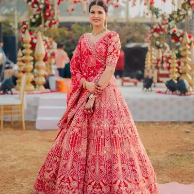 Aditi was a vision in her red bridal lehenga. We created a clean, classic look with a neat bun and makeup that highlighted her sharp features, ensuring she looked absolutely regal for her wedding ceremony. ❤️