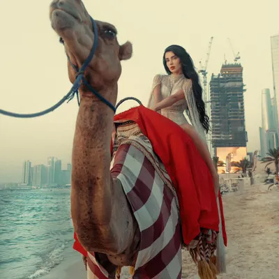 A majestic shot combining the traditional symbol of the desert, a camel, with the modern Dubai skyline. This is the kind of epic destination portrait I love to create.