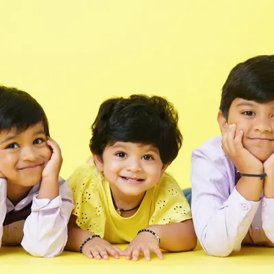 The magic of childhood friendship between siblings and cousins. This bright and happy studio portrait captures their beautiful smiles.