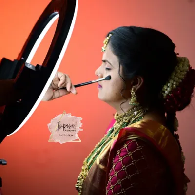 Applying a soft, natural base for a bride's muhurtham look. Using a ring light ensures perfect lighting to see every detail, a tip I share in my online classes for getting your makeup just right.