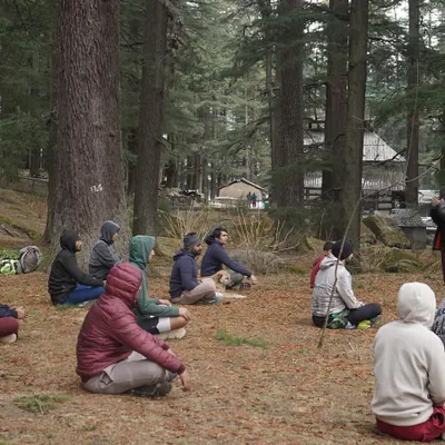 A certified instructor leads our group through a meditation session deep in the Van Vihar forest. Finding stillness and focus is a key part of our training philosophy.