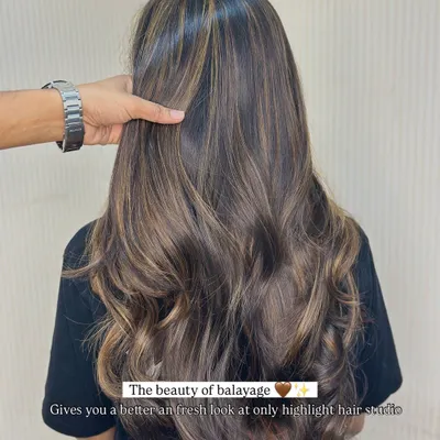 The beauty of balayage. Look at how these hand-painted highlights create a fresh, dimensional look on this client's long hair, styled with soft waves.