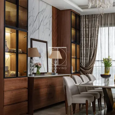 This dining room is all about the interplay of materials. We paired our Michelangelo stone-top dining table with a rich wooden credenza and display unit, creating a space that feels both warm and luxurious.