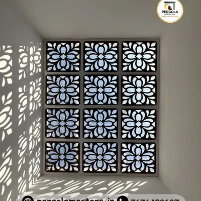A stunning skylight featuring a floral, laser-cut jali pattern that casts beautiful, artistic shadows on the walls below. This design turns natural light into a dynamic decorative element, brightening the space with elegance.