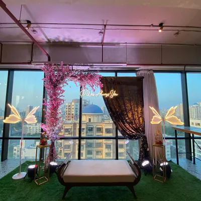 An intimate and romantic setup perfect for a proposal or engagement photo shoot. We created a floral arch with a custom neon sign against a city view, making the moment truly special.