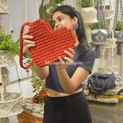 I love this heart-shaped macramé bag! It's a fun and quirky accessory that's perfect for adding a pop of color and personality to any outfit.