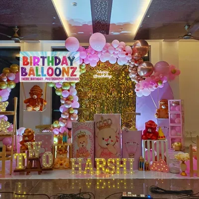 This is a full view of a teddy bear theme I created for a first birthday. The setup is rich with details, including teddy bears on swings, pink and gold balloon arches, themed pedestals, and light-up letters spelling "HARSHI".