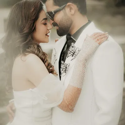 A close-up, dreamy portrait of the couple. The soft focus and their gentle expressions create an intimate and romantic atmosphere, perfectly capturing their love.