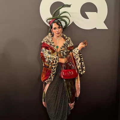 A full-length shot of influencer Neha Singh at the GQ Best Dressed event. I created her vintage-inspired hairstyle, complete with a feathered headpiece, to perfectly match the event's theme and her extravagant outfit.