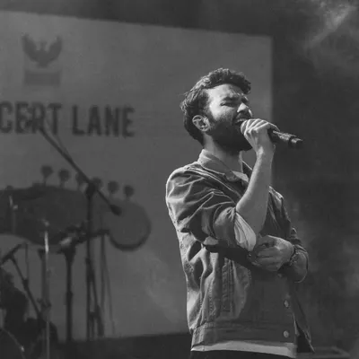 A black and white shot that captures the feeling of being completely absorbed in a song on stage.
