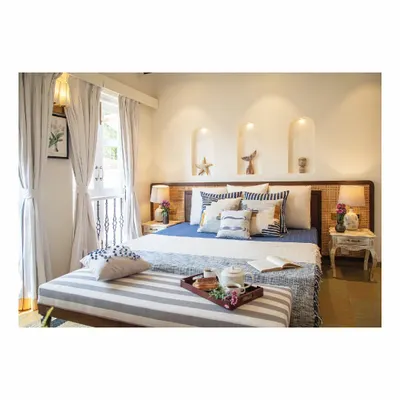 For this holiday home bedroom, the mood board was all about sun and waves. We used a cool palette of blues and whites, natural cane headboards, and striped fabrics to evoke a breezy, tropical feeling, perfect for a peaceful escape.