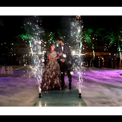 A show-stopping reception entrance with cold pyro fireworks creating a magical, star-lit path for the couple. This is how you make an entrance.