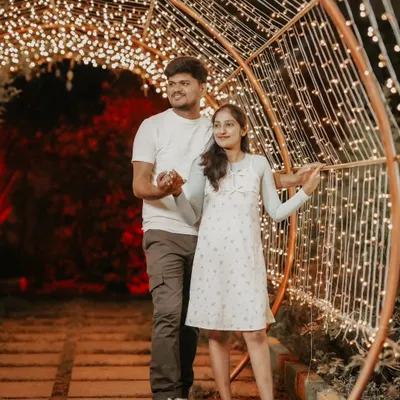 A fun and candid moment inside our fairy light tunnel. This is one of our most popular sets for creating magical pre-wedding photos at night.