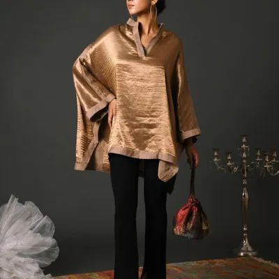 For this festive season campaign, I styled a lustrous gold kaftan top with sleek black trousers. The art direction focused on creating a sense of understated luxury, perfect for elegant evening wear.