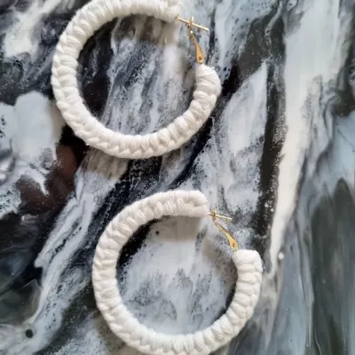 My classic macrame hoop earrings in a clean, natural white. They are incredibly lightweight and add a touch of bohemian elegance to any look.