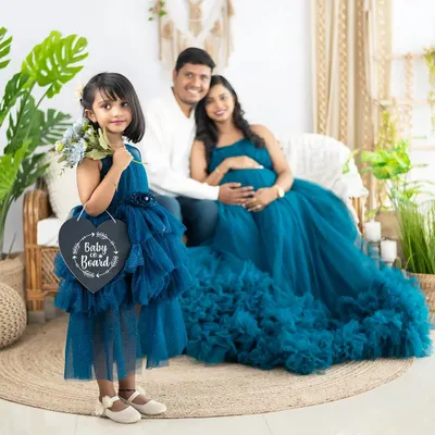Another adorable way to announce a new arrival. The older sister holds a 'Baby on Board' sign, officially including her in the family's growing story.
