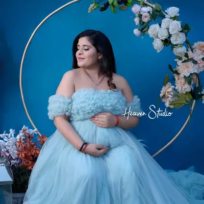 This ethereal, off-the-shoulder tulle gown in a soft powder blue is a client favorite. It creates a dreamy, fairytale look perfect for a magical studio session.