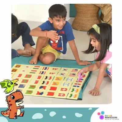Friendship begins with shared exploration. Here, two children work together on a flag matching game, learning about the world and each other.