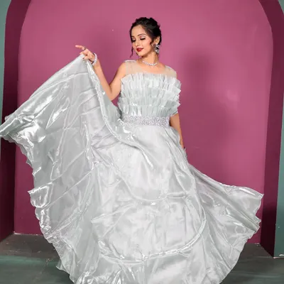 This shimmering light blue gown creates a fairytale moment. The flowing organza fabric and ruffled bodice are perfect for a pre-wedding shoot or a glamorous evening event.