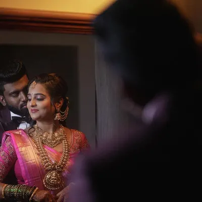 A reflective portrait of a couple during their evening reception. I often use creative compositions, like this shot in a mirror, to add an artistic and intimate feel to my wedding reception photography.
