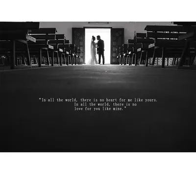 A dramatic black and white silhouette of a couple standing at the church doorway, a powerful and cinematic start to their life together.