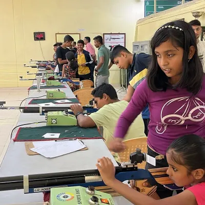 Young participants learning to handle air rifles at the 10m shooting range. I provide hands-on guidance to ensure every child learns safely and effectively.