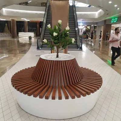 I love creating functional art, like this custom circular bench with an integrated planter at Lulu Hypermarket. It provides seating for shoppers while seamlessly incorporating a beautiful artificial flowering tree, making it a natural centerpiece for the corridor.